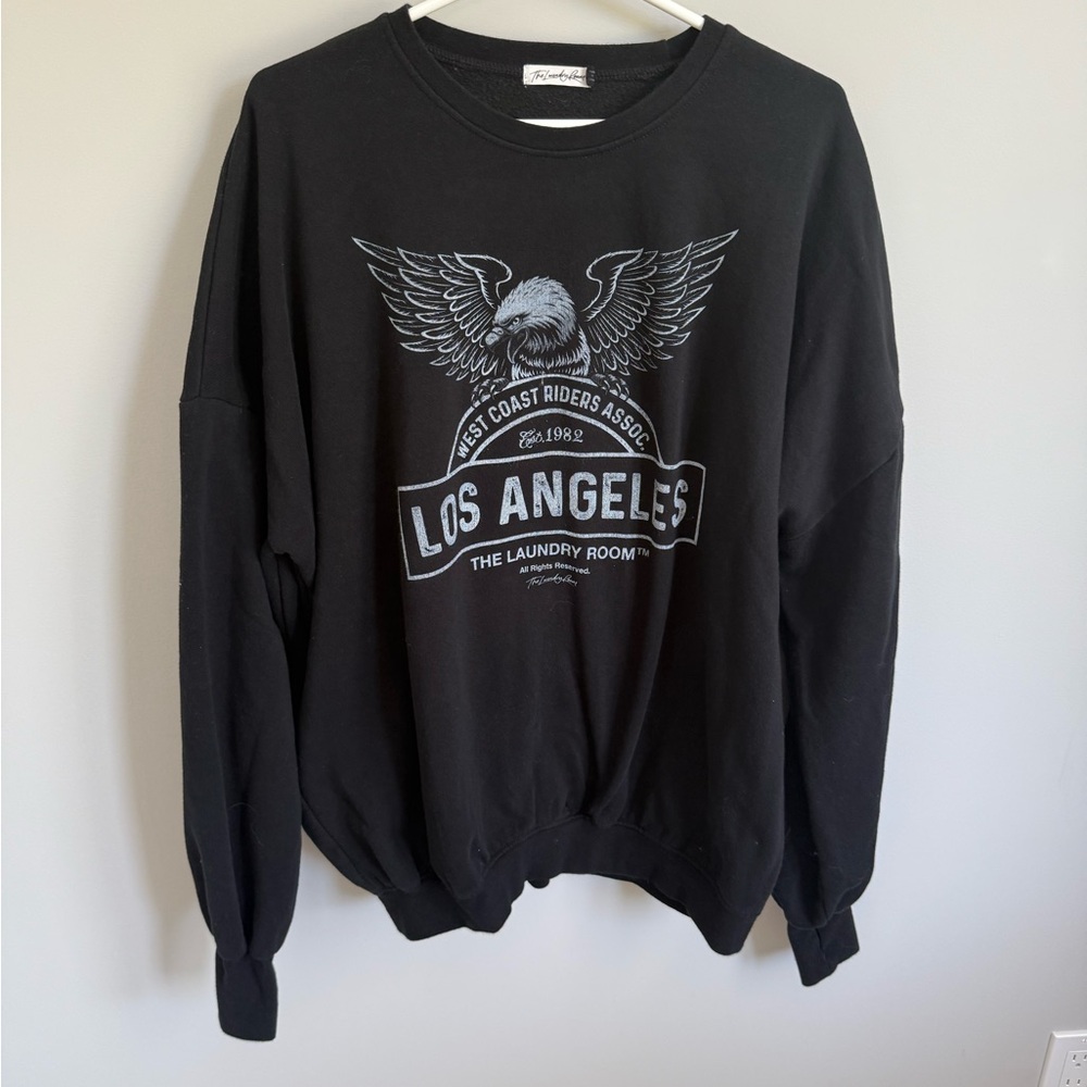 Black Los Angeles Graphic Sweater by the laundry room